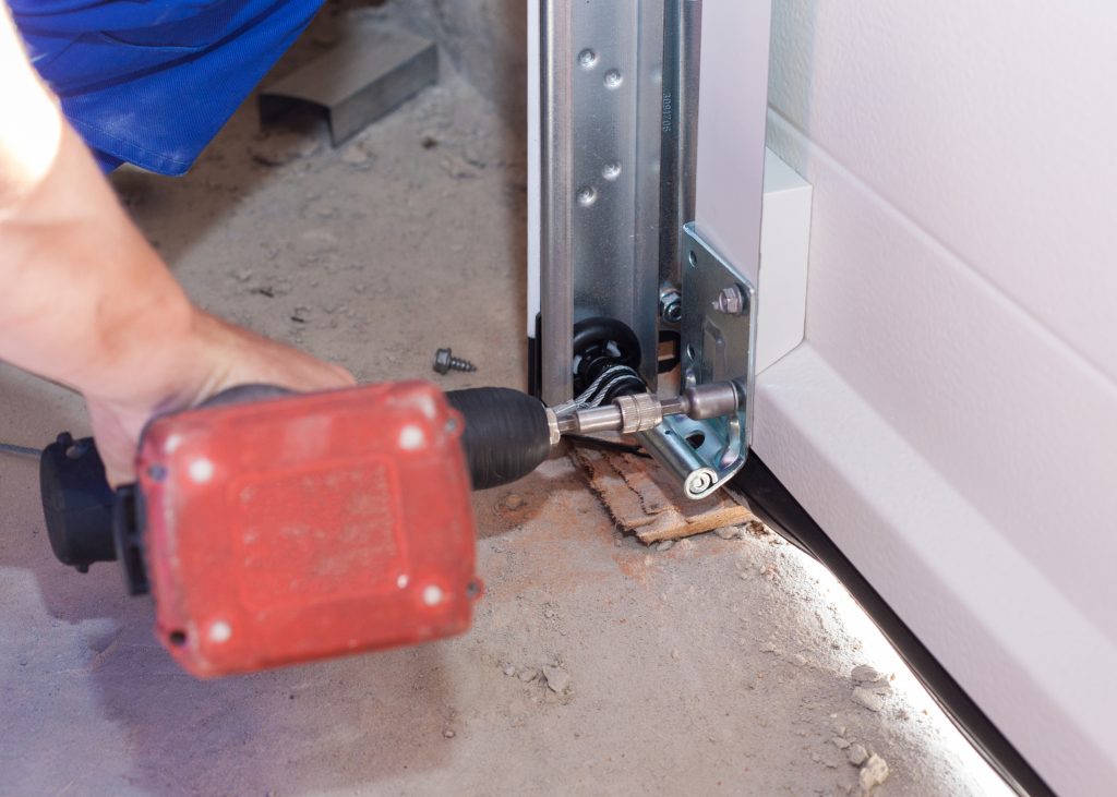 garage door technician installing garage door components in cranberry township